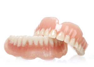 full set of dentures on white background