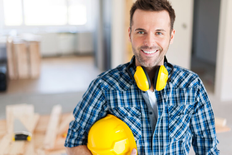 A smiling construction worker with healthy teeth.